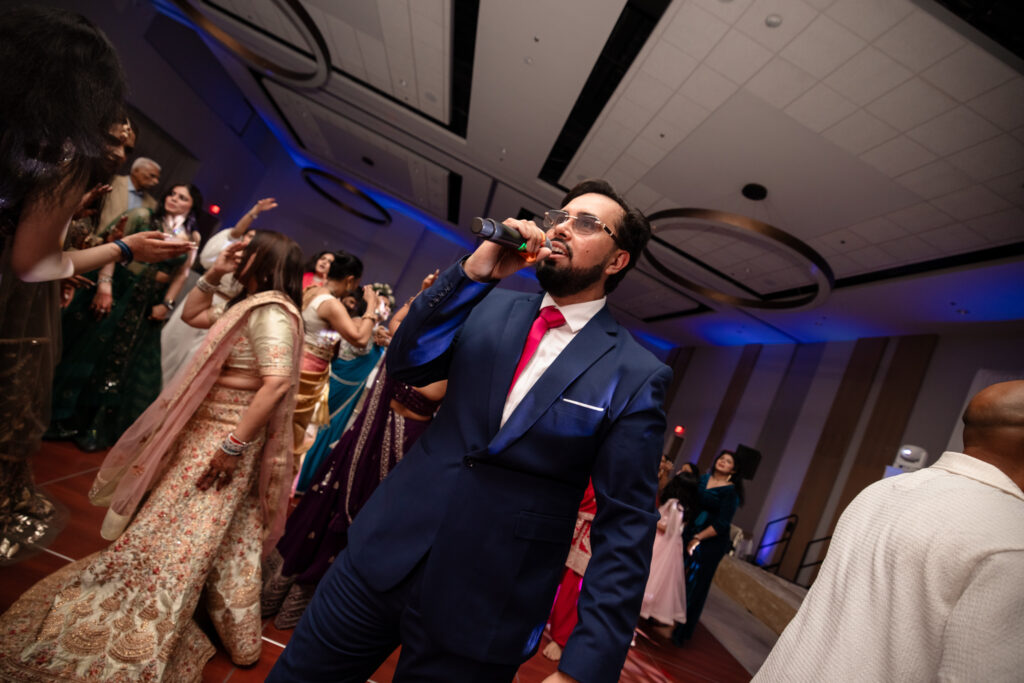 DJ Pram, as an experienced Indian Wedding MC on the dancefloor hyping the crowd up.