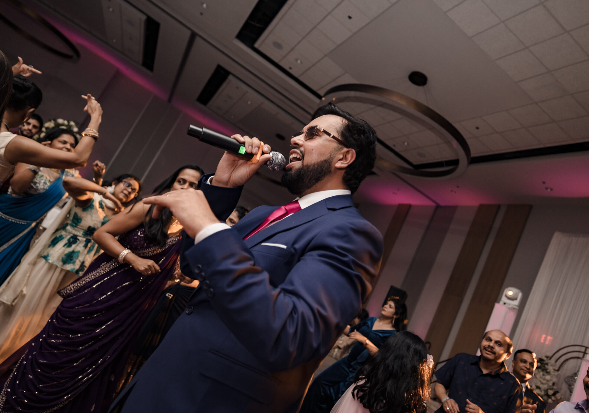 DJ Pram, as an experienced Indian Wedding MC on the dancefloor hyping the crowd up.